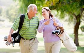 senior couple playing golf